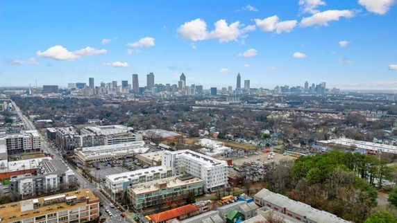 Wide-angle aerial view of a cityscape with skyscrapers and urban areas.