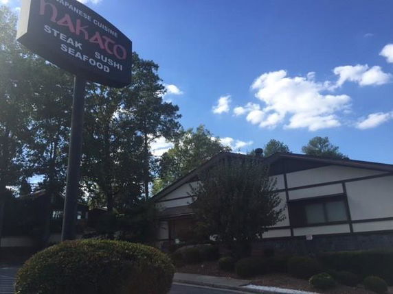 Front view of a Japanese restaurant building with a sign for steak, sushi, and seafood.