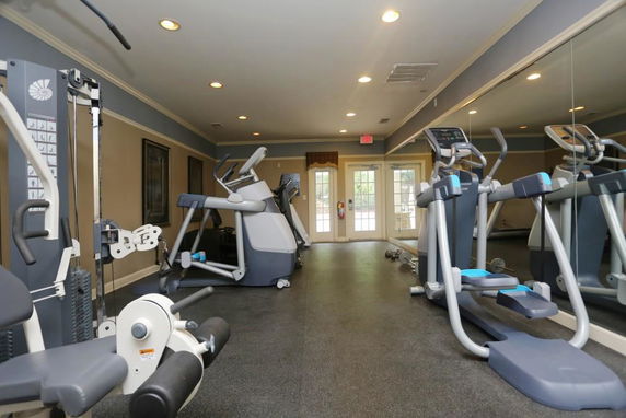 Indoor view of a gym with exercise equipment like treadmills and weight machines.
