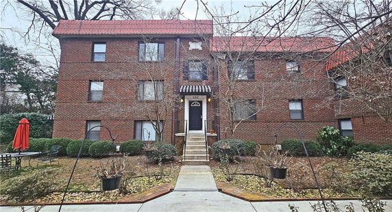 Front view of a three-story brick apartment building.
