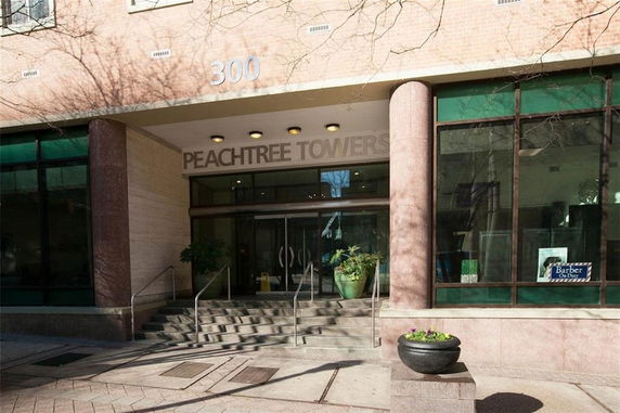 Front view of a multi-story building entrance with Peachtree Towers signage.
