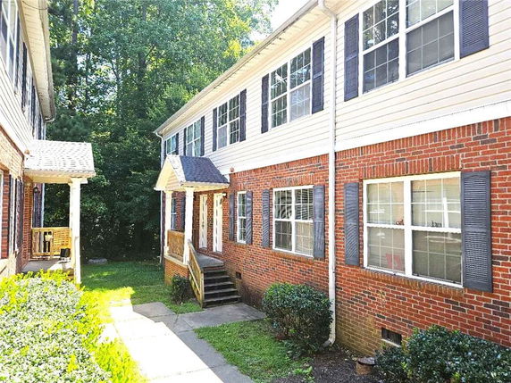 Front view of a two-story brick building with multiple windows.