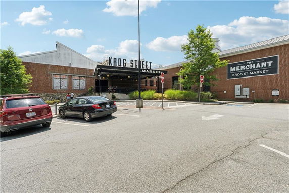 Front view of a market building with brick facade and signage.
