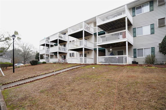 Front view of a multi-story residential building with multiple balconies.