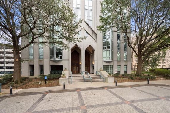Front view of a modern building with large windows and tall entryway.