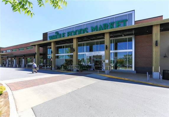 Front view of a commercial building with large entrance and signage.