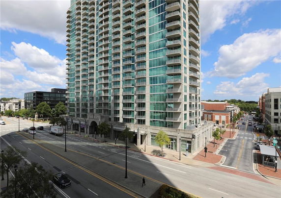 Front view of a high-rise building with multiple balconies.