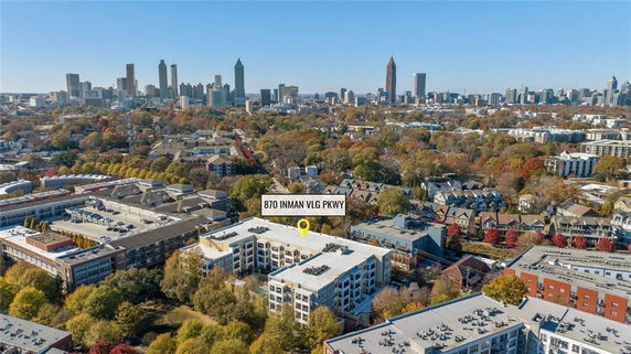 Aerial view of a cityscape with buildings and greenery, showcasing a specific building marked with an address.