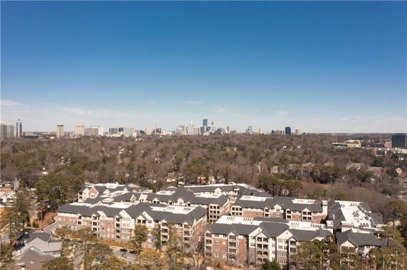 Panoramic view of multiple residential buildings with a city skyline in the background.