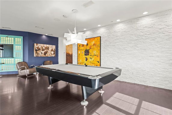 Room with a pool table and modern decor.