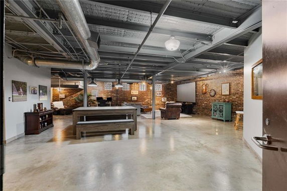 Interior view of a recreational space with seating and a game area.