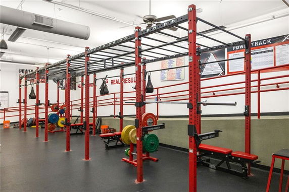 Gym area with weightlifting equipment and a monkey bar setup