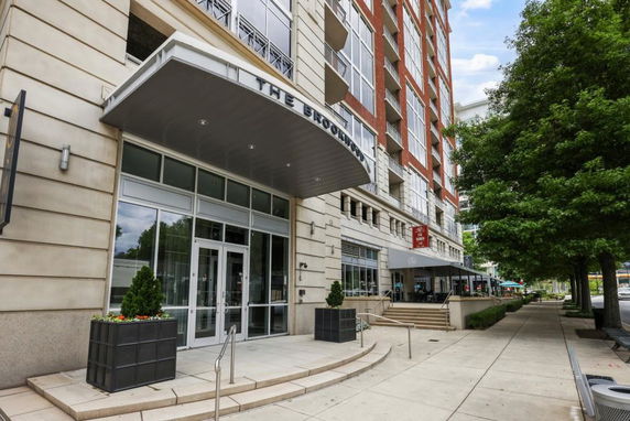 Front view of a multi-story building with a large entrance canopy.