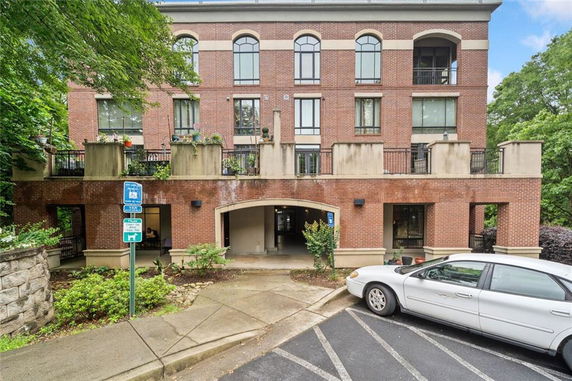 Front view of a multi-story brick building with balconies.