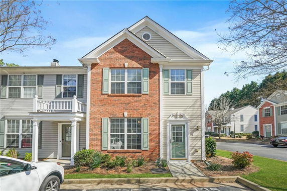 Front view of a two-story townhome with brick and siding exterior.