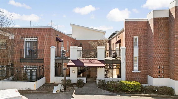 Front view of a two-story brick building with balconies.