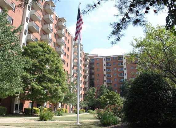 Front view of a multi-story apartment building with balconies.