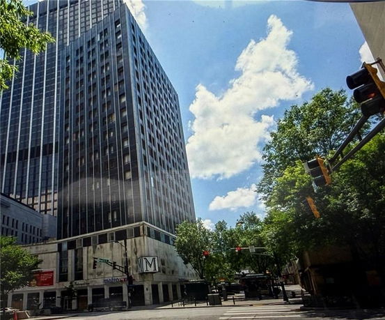 Front view of a tall office building with numerous windows.