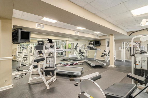 Interior view of a gym with various exercise machines and equipment.