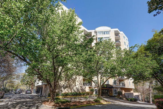Front view of a multi-story apartment building with balconies.
