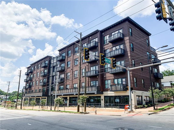 Front view of a multi-story apartment building with balconies.