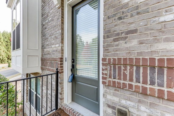 Exterior view focusing on the entrance door of a brick house.