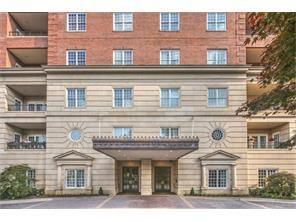 Front view of a multi-story building with decorative facade and entrance canopy.