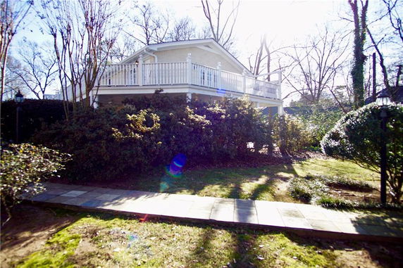Front view of a house with an elevated terrace.