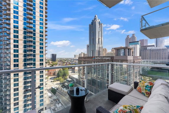 Balcony view of a cityscape with tall buildings.