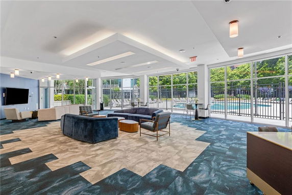 Interior view of a recreational area with seating and large windows.