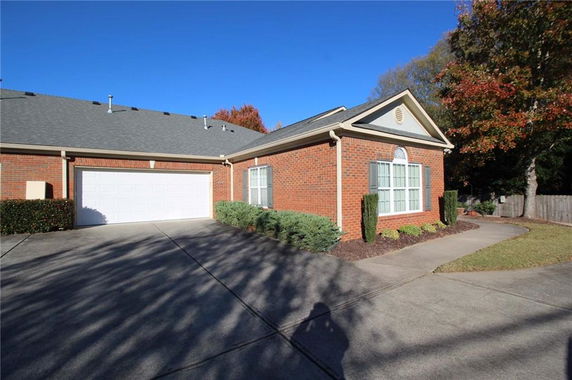 Front view of a single-story brick house with a double garage.