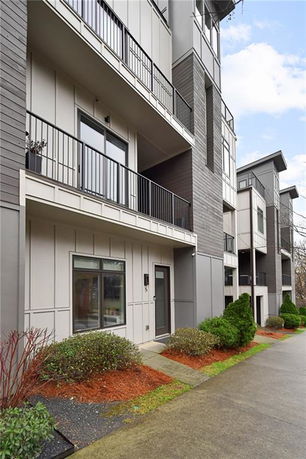 Front view of a multi-story building with balconies and modern design.