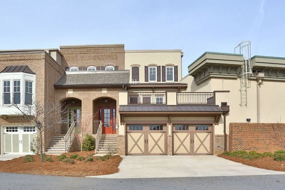 Front view of a two-story house with a double garage and brick exterior.