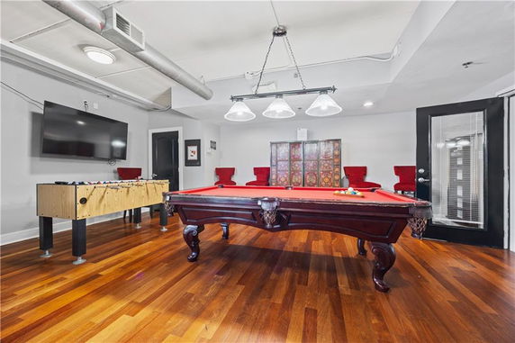 Indoor recreation room with a pool table and foosball table.