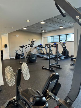 Indoor gym area with exercise machines and equipment.