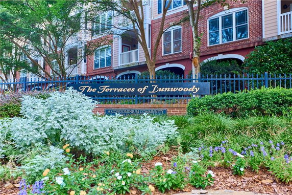 Front view of a condominium complex with a sign reading 'The Terraces of Dunwoody'.