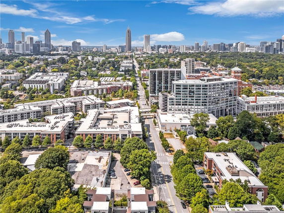 Panoramic view of a cityscape with various buildings and a skyline in the distance.