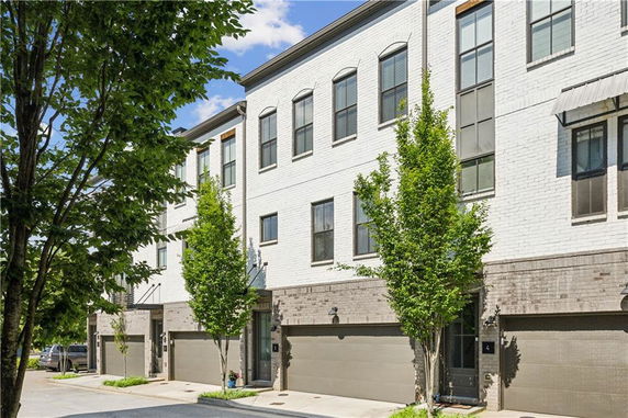 Front view of a multi-story residential building with garages.