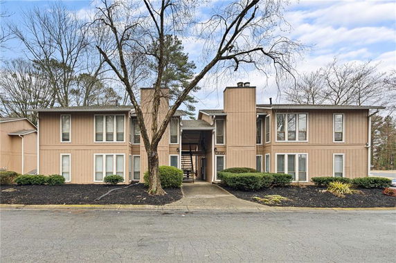Front view of a two-story building with a central entrance and symmetrical windows.