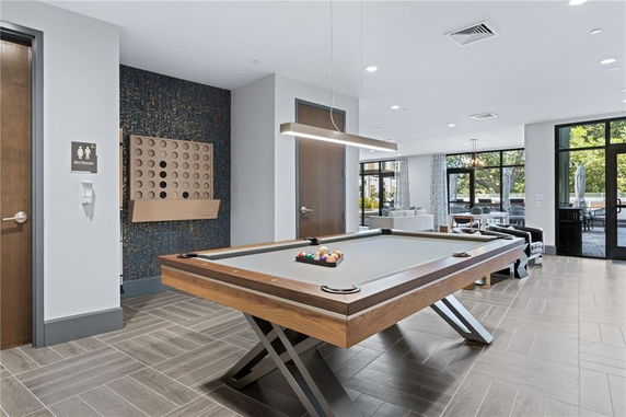 Indoor area with a pool table and seating, suitable for recreational activities.