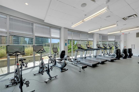 Interior view of a gym with treadmills and exercise bikes.