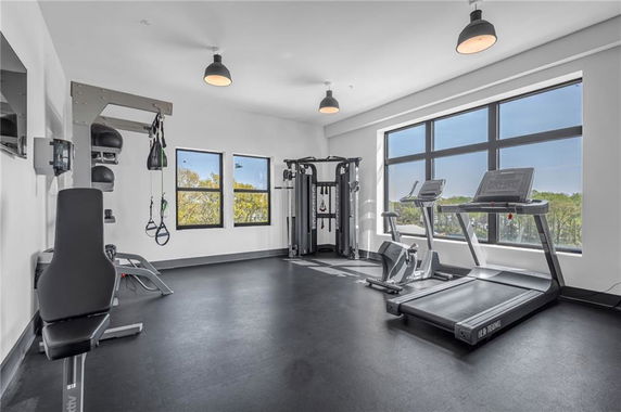 A gym area with exercise equipment including a treadmill and weight machines.