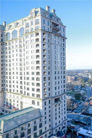 Front view of a multi-story building with a detailed architectural design.