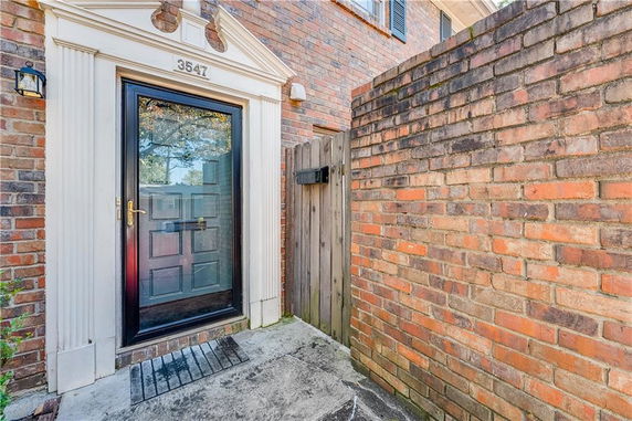 Front view of a brick exterior with a glass door entrance.