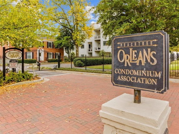Front view of a condominium complex entrance with signage.