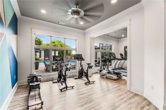 Indoor gym area with exercise equipment and large windows.