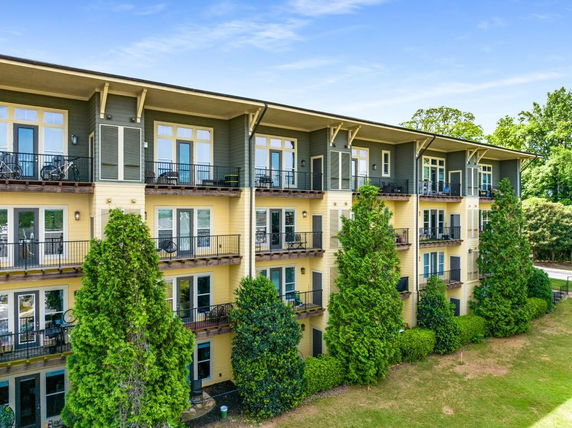 Front view of a multi-story residential building with balconies.
