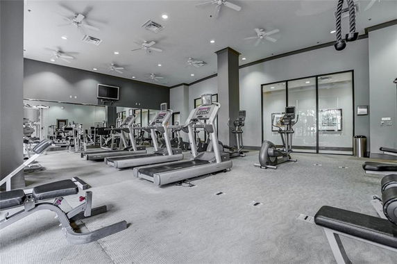 Interior view of a gym area with treadmills and exercise equipment.
