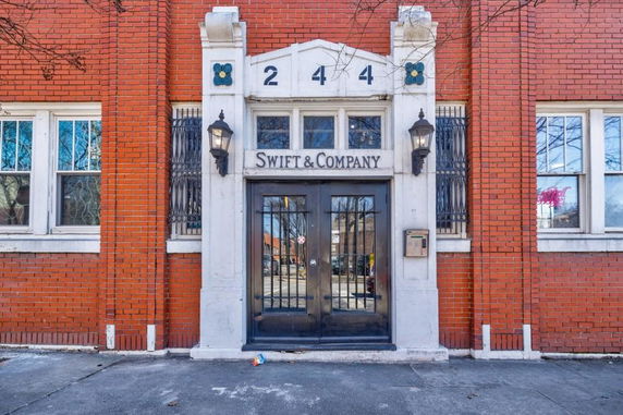 Front view of a brick building with a central entrance, displaying the name Swift & Company.