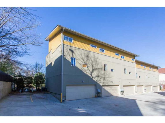 Front view of a multi-story building with garage entrances.